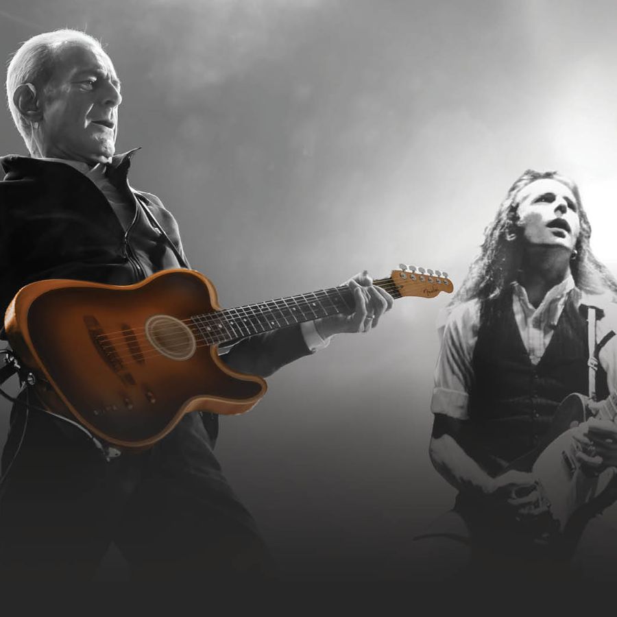 two men playing guitars, including Francis Rossi