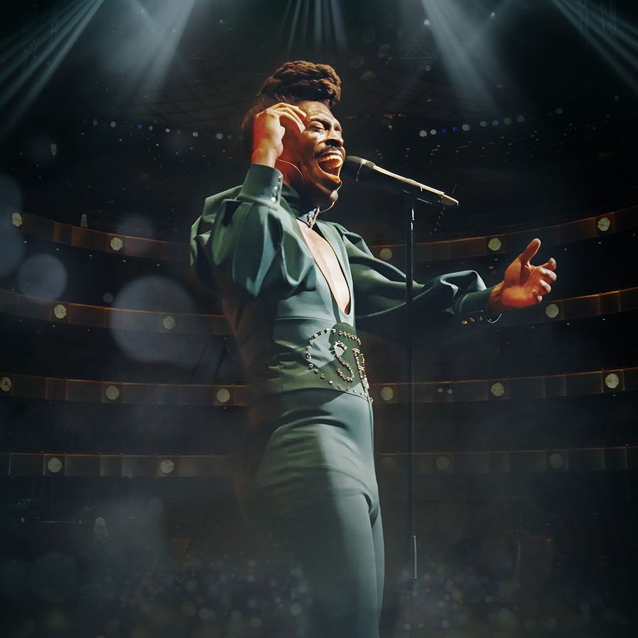 A man dressed in green, singing into a microphone with enthusiasm