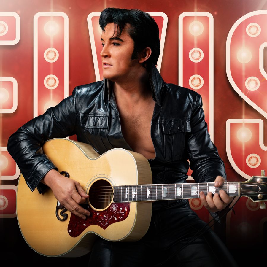Ben Portsmouth with guitar in front of bright Elvis sign