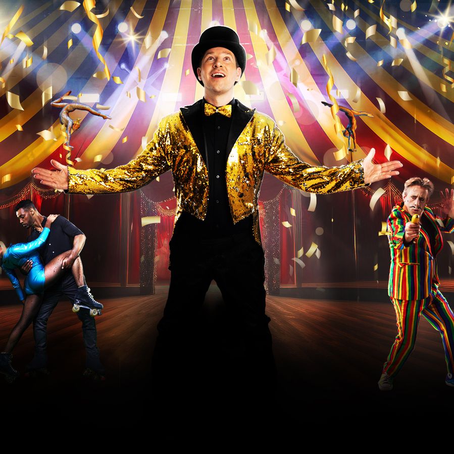 A man in a colorful circus costume stands confidently on stage, ready to entertain the audience